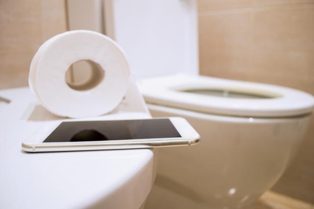 Dirty, Germ-Laden Phone on Toilet Bowl